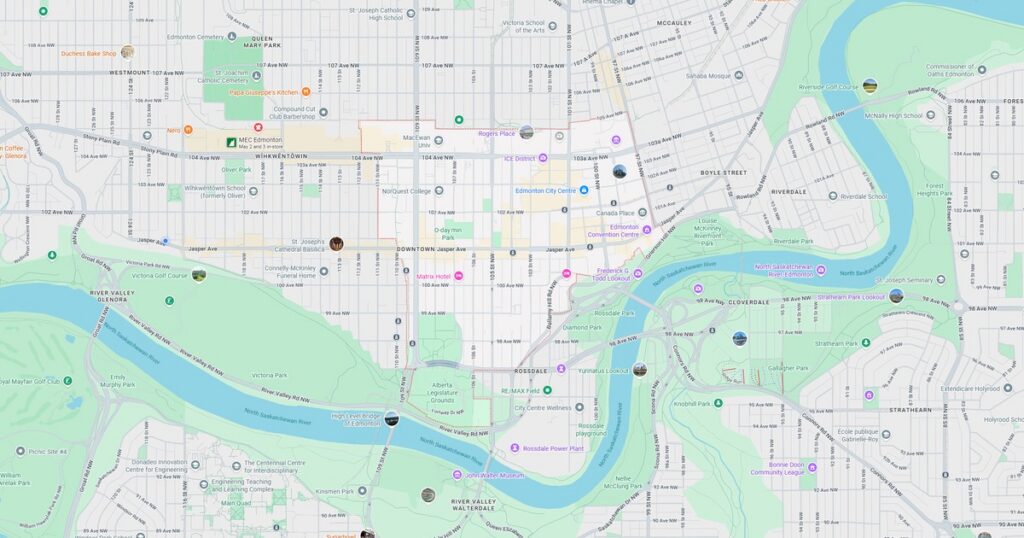 Map of downtown area showing streets, parks, and river in a city.