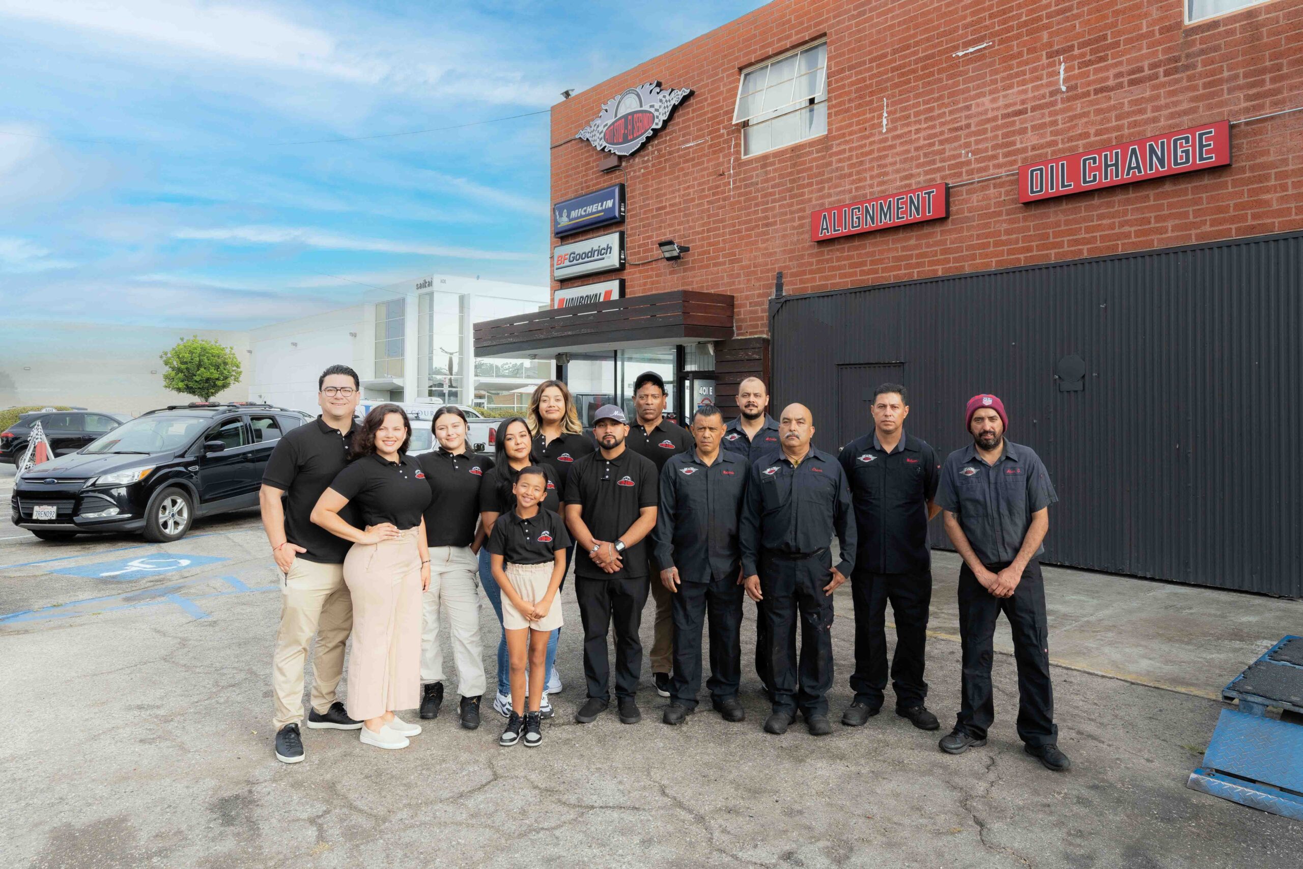 Skilled auto repair team at Pittstop Auto Care in front of the service center.