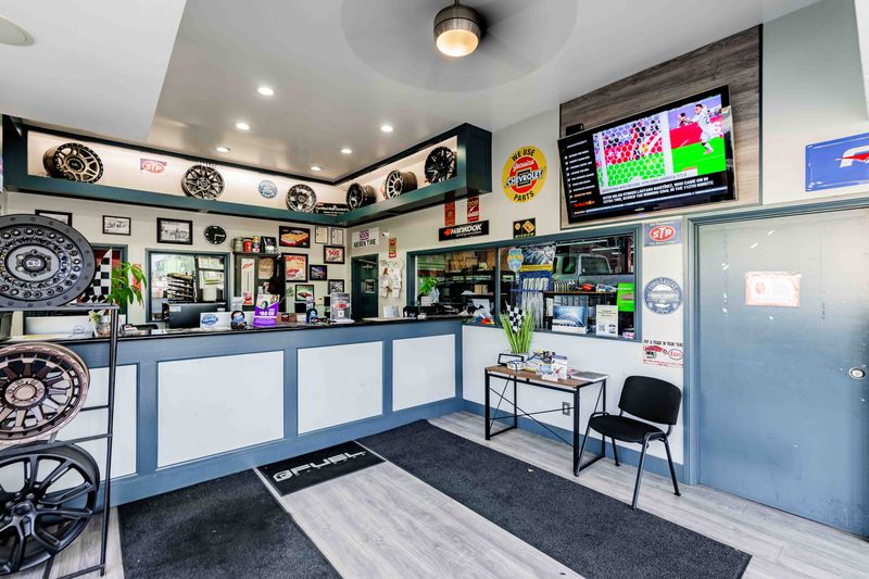 Modern auto repair shop interior with service counter and automotive decor.