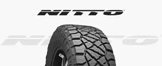 Close-up of rugged tire with tread pattern at Pittstop Auto Care.
