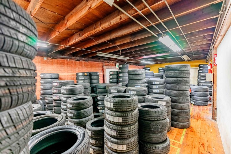 Tire storage with stacks of tires in a garage at Pittstop Auto Care.