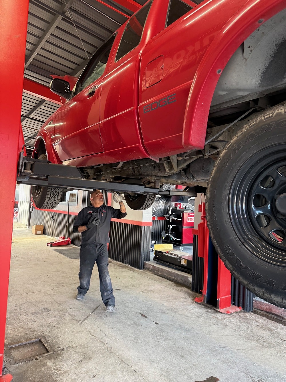 Vehicle lifted at Pittstop Auto Care for maintenance or repair.