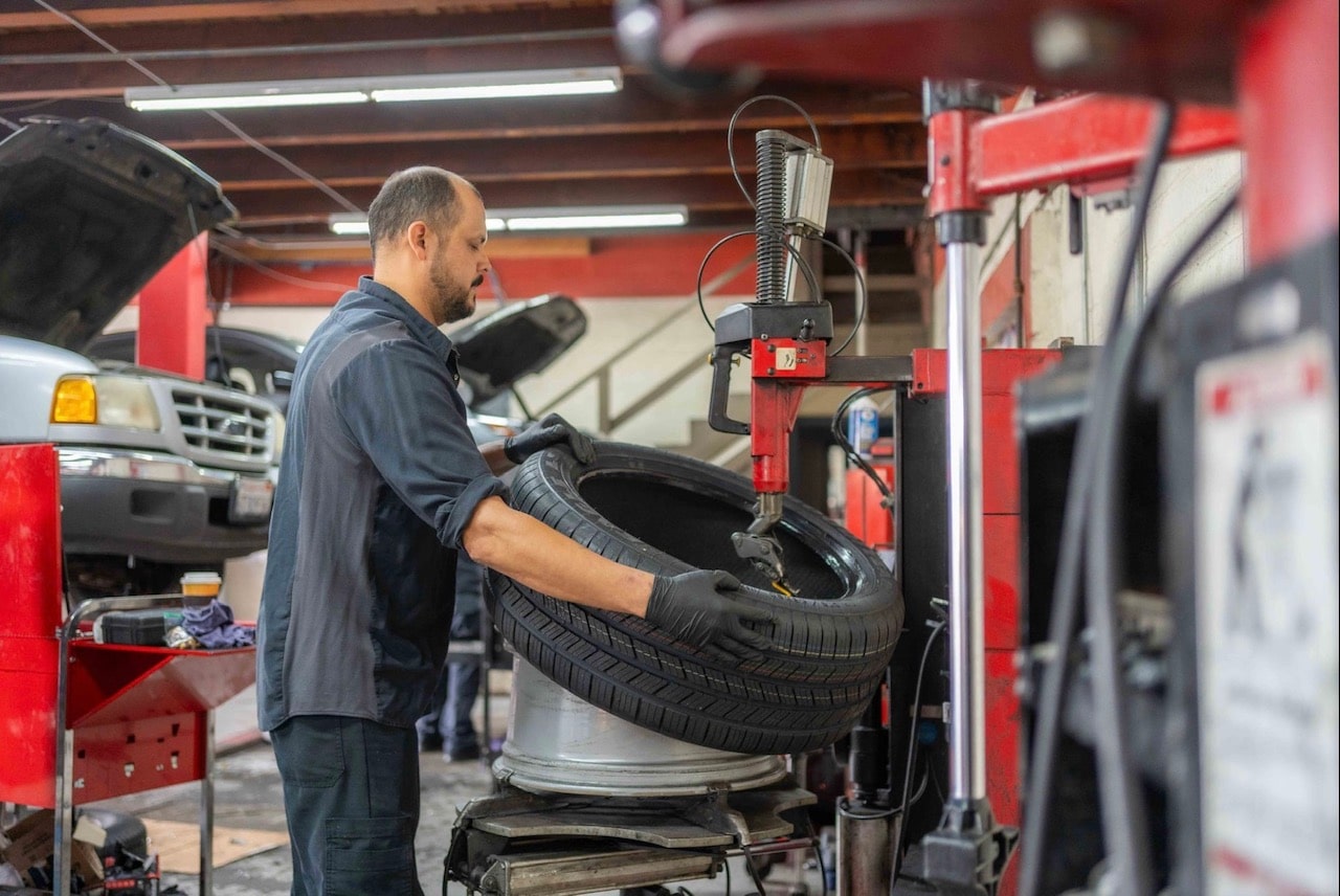 Skilled technician replacing a car tire at Pittstop Auto Care.