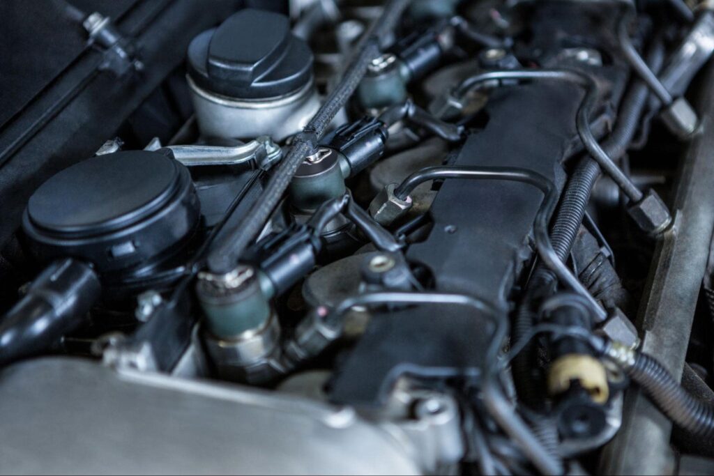 Engine components and parts in a vehicle's engine bay.