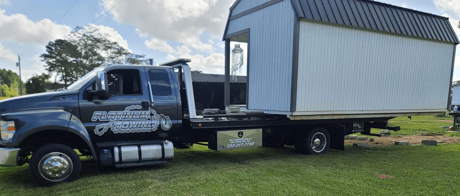 Flatbed tow truck from Johnny's Automotive for vehicle recovery and roadside assistance.