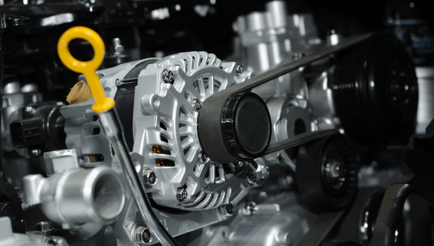 Close-up of a car engine with belts and pulleys, showcasing automotive repair services.