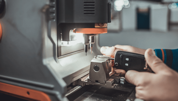 Skilled technician using machinery at Johnny's Automotive for vehicle repair.