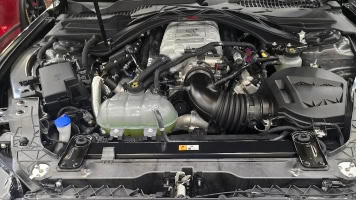 Close-up of Johnny's Automotive engine showing detailed components and repair work.