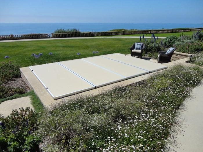 Small pool covered with a blue tarpaulin during the winter season to cover it and prevent dirt.