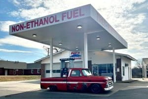 Non-ethanol fuel station with a pickup truck in front, fueling pumps visible.
