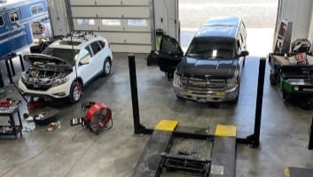 Auto repair shop with vehicle lifts and tools.