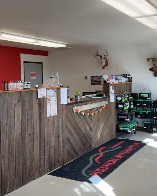 Auto repair shop reception desk with tools and supplies.