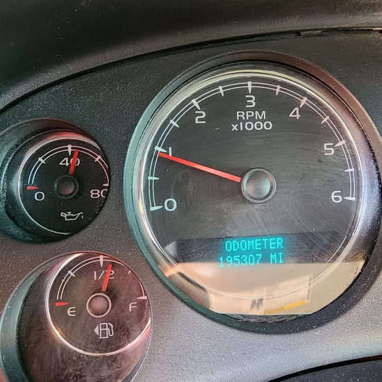 Engine RPM gauge and odometer reading in a vehicle dashboard.