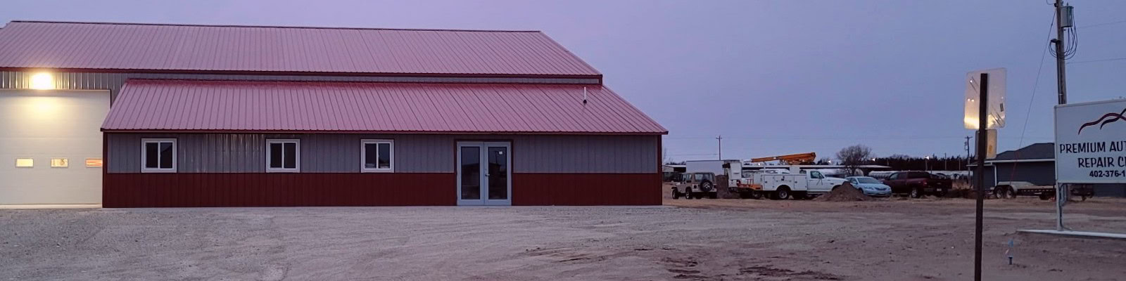 Auto repair shop exterior with red building and service area.