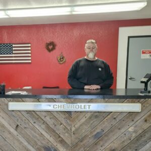 Reception area at Premium Auto Repair Inc with staff behind the counter.
