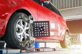 Car being mounted and balanced on a wheel alignment machine at Price Tires & Wheels.