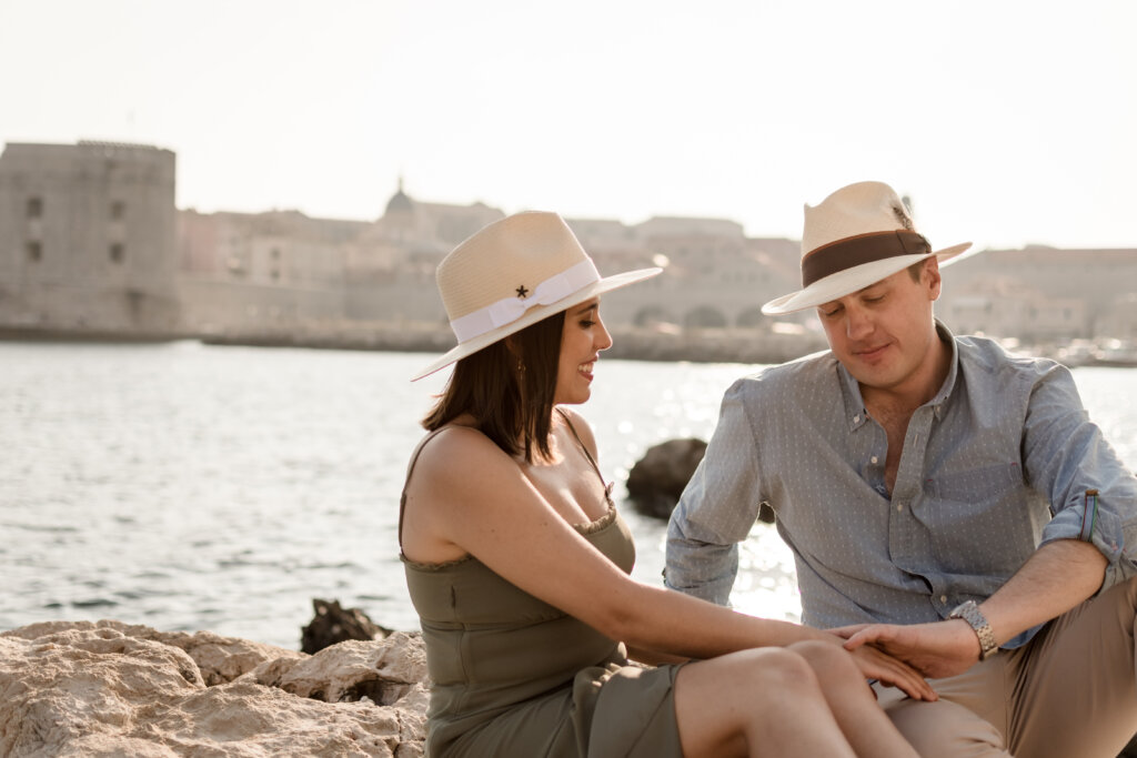 Couple talking in Dubrovnik Old Town walls at sunset