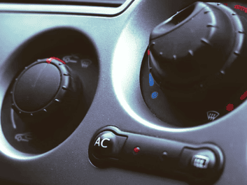 Auto air conditioning and heater control panel in vehicle dashboard.