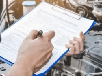 Auto repair service technician inspecting vehicle diagnostics.