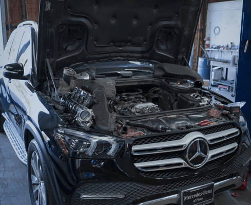 Mercedes-Benz engine under repair at Qwik Oil & Auto Care.