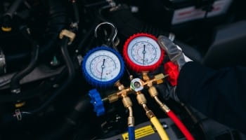 HVAC system gauges and tools at Qwik Oil & Auto Care for vehicle air conditioning repair.
