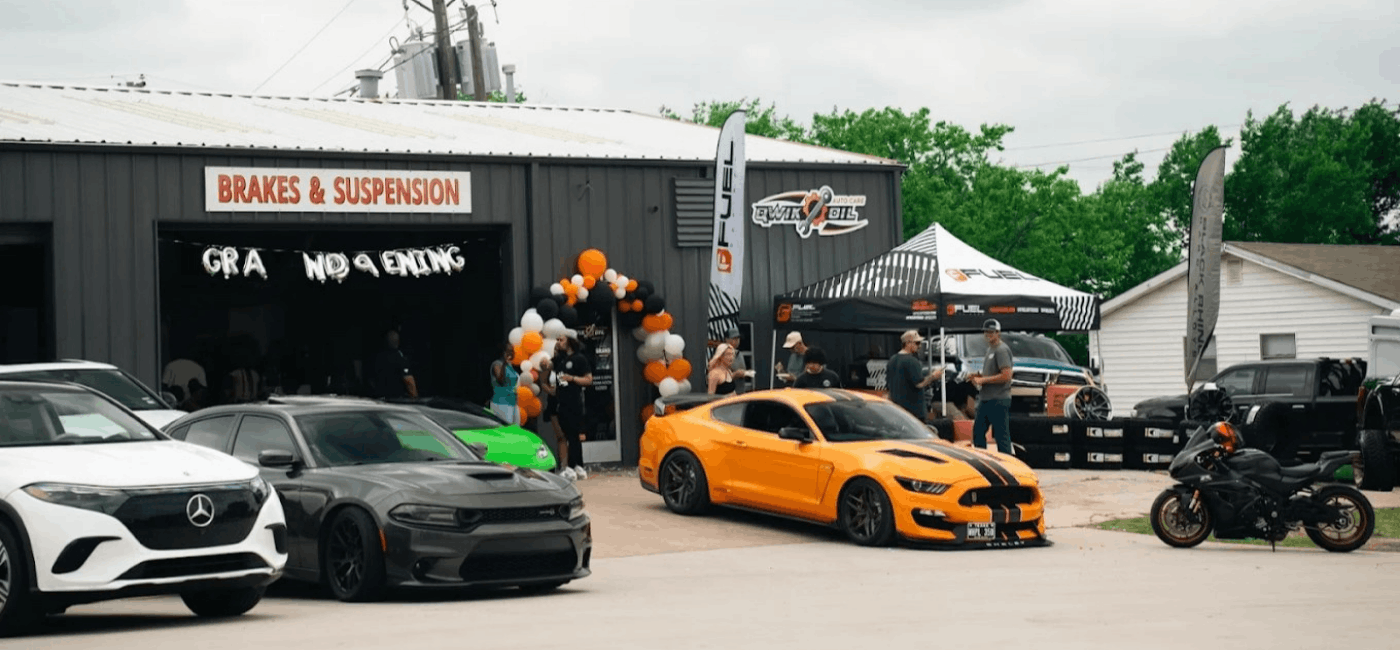 Qwik Oil & Auto Care grand opening with cars and service station.