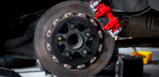 Close-up of a vehicle brake disc and red caliper at Rapid Fleet Service.