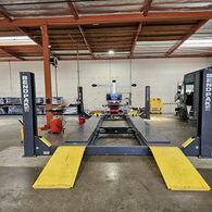Commercial vehicle lift in a professional auto service shop.