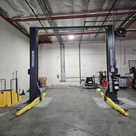 Industrial vehicle lift in a garage for fleet maintenance and repairs.