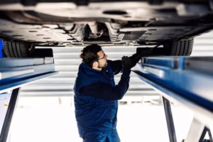 mechanic-fixing-tire-while-standing-car