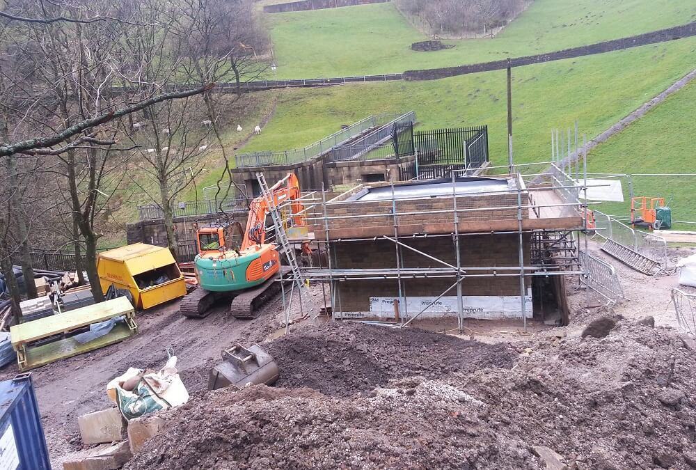 Turbine house emerges out of the ground at Dovestone Reservoir