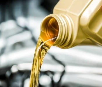 Fresh motor oil being poured during an oil change at Rob & Son Garage.