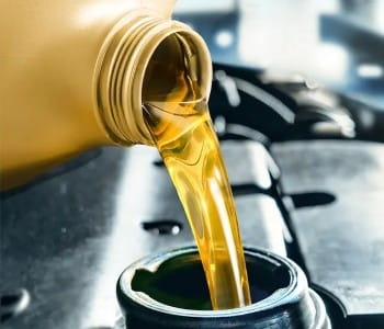 Automotive oil being poured during a service at Rob & Son Garage.