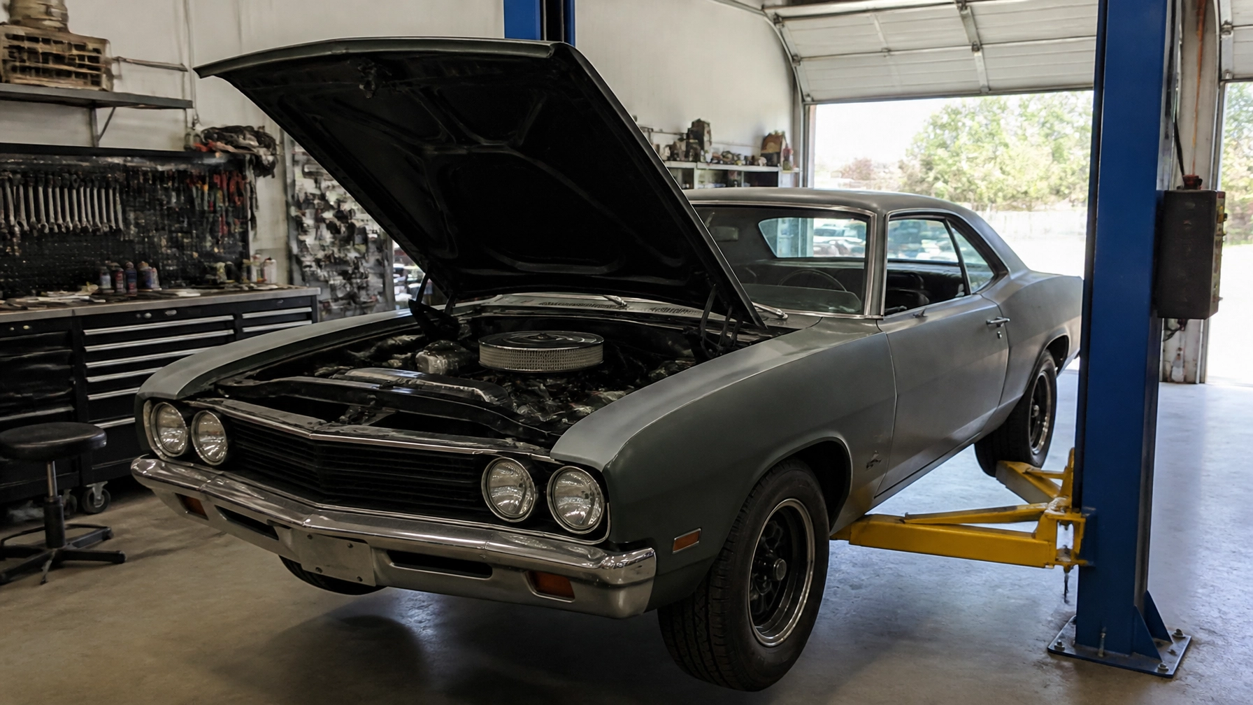 Vintage 1970s muscle car with open hood at Rob & Son Garage.