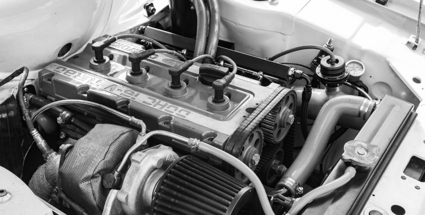 Automotive engine with clean components and hoses in a car engine bay.