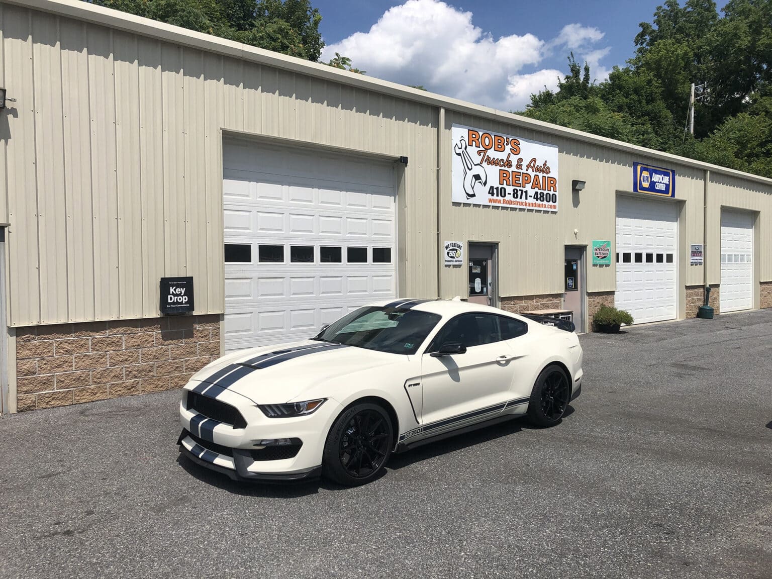 Ford Mustang sports car outside Rob's Truck & Auto Repair shop, auto repair and maintenance services.