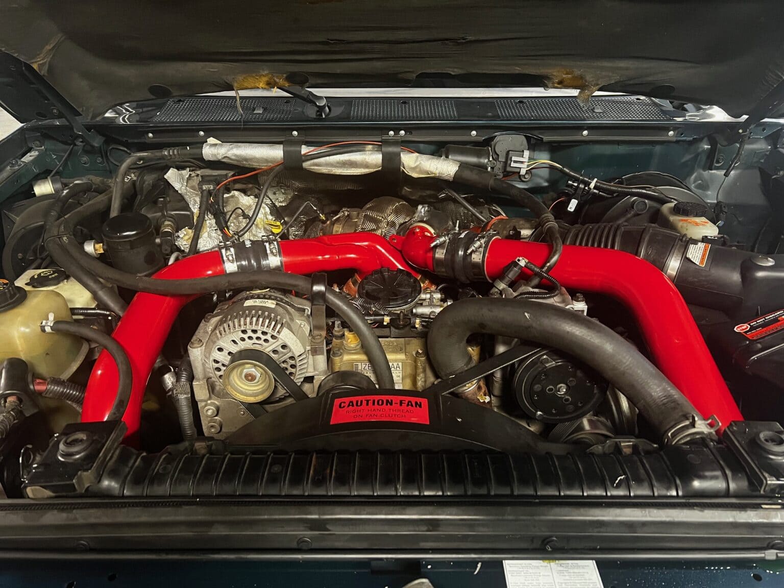 High-quality car engine with red turbo intercooler pipes, showcasing auto repair and performance upg.