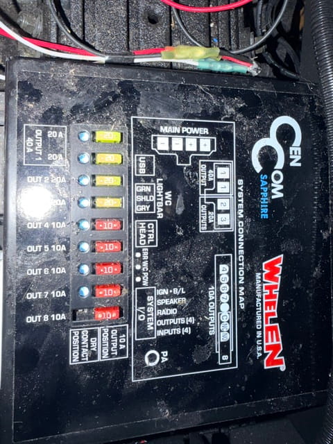 Close-up of vehicle fuse box with labeled fuses and relays at Rob's Truck & Auto Repair.