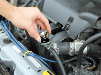 Engine oil being checked during auto repair service.