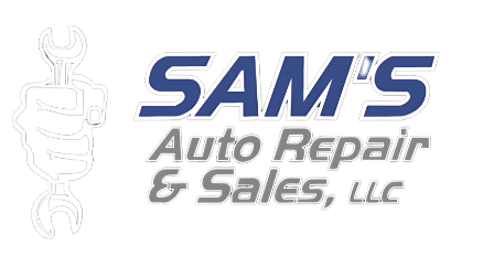 Auto repair shop with tools and equipment outside the garage.