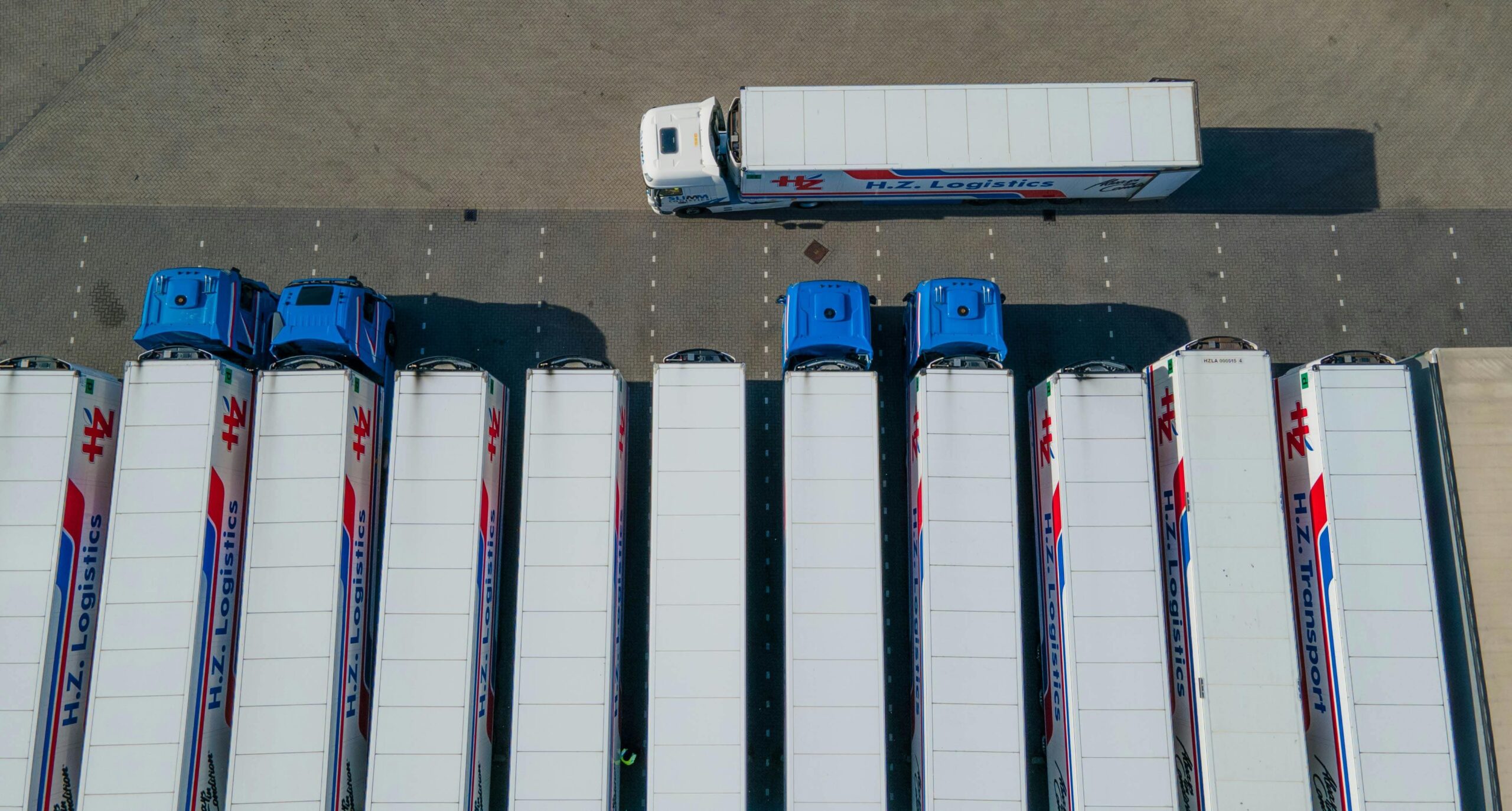 Aerial view of multiple semi-trucks parked in a lot, highlighting professional fleet maintenance ser.