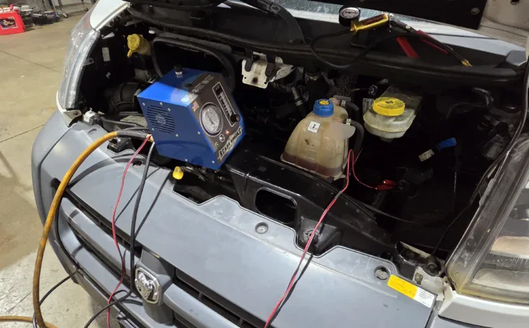 Sanfelippo Auto Repair service image showing vehicle engine bay and diagnostic equipment.