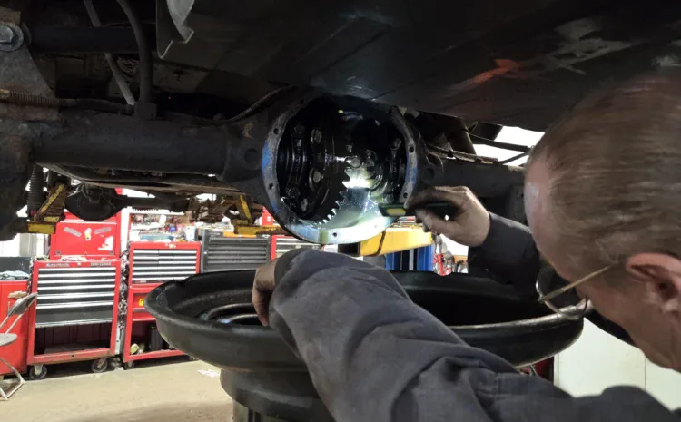 Car differential service being performed at Sanfelippo Auto Repair shop in a well-equipped garage.
