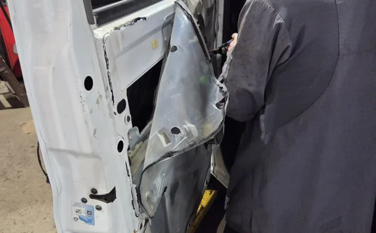 Sanfelippo Auto Repair service with technician inspecting vehicle door panel.