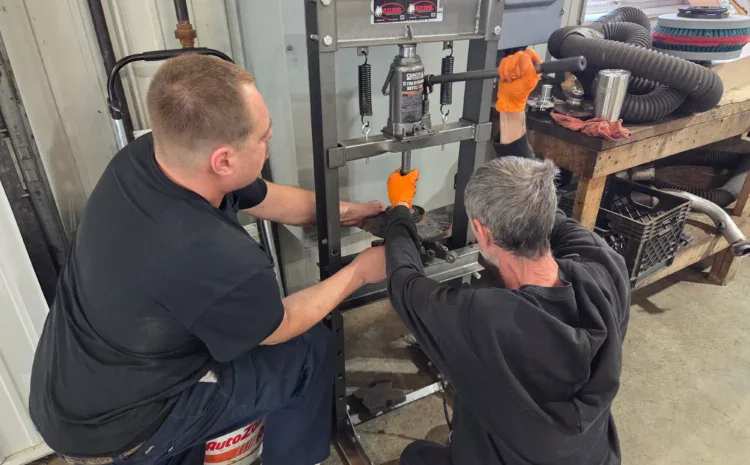 Sanfelippo Auto Repair shop technicians operating heavy machinery.
