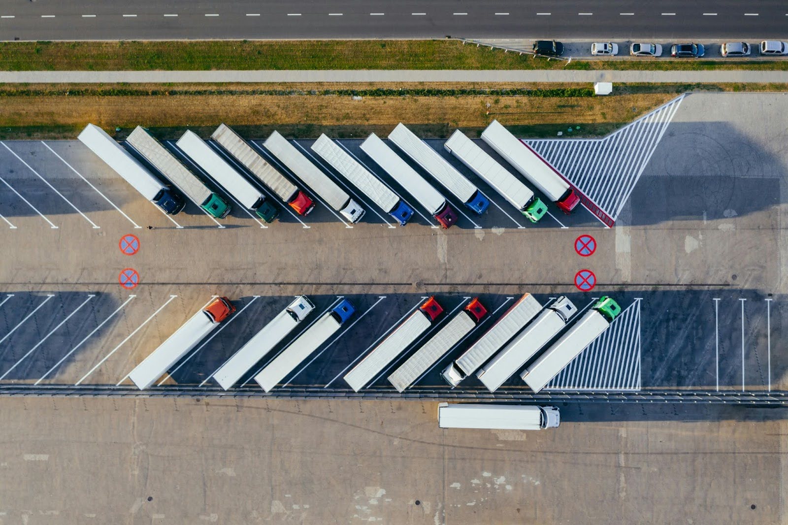 Fleet of commercial trucks parked in a lot, ready for service.