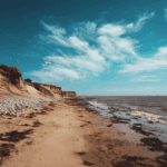 Seaglass hunting on a sandy beach with cliffs and ocean view.