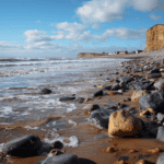 Coastal seaglass hunting beach with pebbles and cliffs, perfect for collecting sea glass and explori.