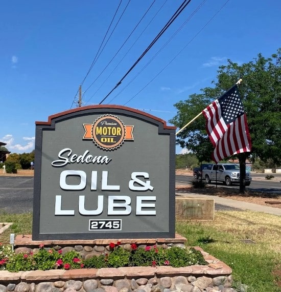 Sedona Oil & Lube service sign with American flag outside the shop.