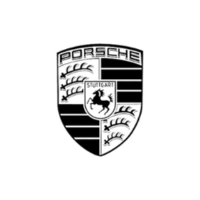 Close-up of Porsche emblem at Senshine Autos dealership.